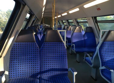 Innenansicht der oberen Etage eines WFL ÖPNV Doppelstockzuges mit blauen 2er und 4er Sitzgruppen